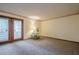 Neutral living room featuring carpet and a glass door leading to a private outdoor space at 2174 Kinridge Rd, Marietta, GA 30062