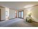 Neutral living room featuring carpet and a glass door leading to a private outdoor space at 2174 Kinridge Rd, Marietta, GA 30062