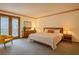 Cozy main bedroom with warm tones, a comfortable bed and a sliding glass door to the balcony at 2174 Kinridge Rd, Marietta, GA 30062