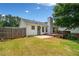View of a spacious backyard with a stained wooden deck and a concrete patio at 3020 River Oak Mews, Decatur, GA 30034