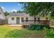 View of a spacious backyard with a stained wooden deck and a concrete patio at 3020 River Oak Mews, Decatur, GA 30034