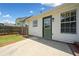 View of home's back door and concrete patio with adjacent lawn and partial fence at 3020 River Oak Mews, Decatur, GA 30034