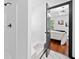 Bright bathroom featuring white tiled walls and shower with an open door to the main bedroom at 3020 River Oak Mews, Decatur, GA 30034
