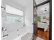 A bright bathroom showcases a soaking tub with a window view and an open door to the main bedroom at 3020 River Oak Mews, Decatur, GA 30034