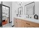 Bright bathroom featuring a double sink vanity, framed mirrors, and a view into the beautifully decorated main bedroom at 3020 River Oak Mews, Decatur, GA 30034