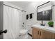 Bathroom featuring a white vanity, modern mirror, bathtub and shower combination, and black fixtures at 3020 River Oak Mews, Decatur, GA 30034