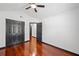 Spacious bedroom with hardwood floors, a ceiling fan, and a closet with double doors at 3020 River Oak Mews, Decatur, GA 30034