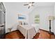 Well-lit bedroom with vaulted ceiling, hardwood floors, and a charming accent table and lamp at 3020 River Oak Mews, Decatur, GA 30034