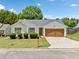 Charming single-story home with manicured lawn and inviting curb appeal on a sunny day at 3020 River Oak Mews, Decatur, GA 30034