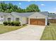 A well-maintained one-story home features a two-car garage, manicured landscaping, and a concrete driveway at 3020 River Oak Mews, Decatur, GA 30034