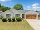 Charming single-story home featuring tidy landscaping, a driveway and a two-car garage at 3020 River Oak Mews, Decatur, GA 30034