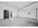 An empty garage features an automatic door opener and a utility door at 3020 River Oak Mews, Decatur, GA 30034