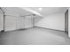 An empty garage features a garage door, automatic door opener, and a utility door at 3020 River Oak Mews, Decatur, GA 30034
