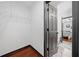 Walk-in closet featuring wire shelving, hardwood floors, and an open door to the main bedroom at 3020 River Oak Mews, Decatur, GA 30034