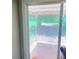 View of the covered backyard patio through the sliding glass door at 401 Mount Tabor Church Rd, Dallas, GA 30157