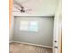 Cozy bedroom featuring a ceiling fan, a window, and neutral carpet flooring at 401 Mount Tabor Church Rd, Dallas, GA 30157