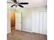 Bedroom with ceiling fan and double closets, offering comfort and functionality at 401 Mount Tabor Church Rd, Dallas, GA 30157