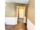Hallway with chair railing, luxury vinyl flooring, and a view of the front door at 401 Mount Tabor Church Rd, Dallas, GA 30157