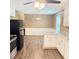Eat-in kitchen with sleek appliances, white cabinets, and luxury vinyl flooring at 401 Mount Tabor Church Rd, Dallas, GA 30157