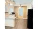Eat-in kitchen with sleek appliances, white cabinets, and luxury vinyl flooring at 401 Mount Tabor Church Rd, Dallas, GA 30157