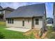 Exterior view of the home showcasing a well-maintained backyard with grass and concrete at 555 Lance View Ln, Lawrenceville, GA 30045