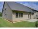 Exterior view of the home showcasing a well-maintained backyard with grass and concrete at 555 Lance View Ln, Lawrenceville, GA 30045