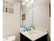 Cozy powder room featuring a dark vanity and framed mirror at 555 Lance View Ln, Lawrenceville, GA 30045