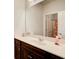 Bright bathroom with a large mirror, dark vanity, and white countertop and including shower at 555 Lance View Ln, Lawrenceville, GA 30045