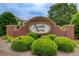 A welcoming brick sign for Jacob's Farm, surrounded by lush green bushes, creates an inviting entrance to the neighborhood at 555 Lance View Ln, Lawrenceville, GA 30045