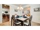 Dining room showcasing a dining table set for four with seamless transition to a living space and a kitchen at 555 Lance View Ln, Lawrenceville, GA 30045