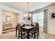 Dining room featuring a glass top table set for four and views of an entryway and living spaces at 555 Lance View Ln, Lawrenceville, GA 30045