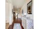 Bright entryway with hardwood floors, elegant wainscoting, a decorative mirror, and a view into the living area at 555 Lance View Ln, Lawrenceville, GA 30045