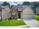 Charming home featuring stone and brick exterior with a well-manicured lawn and attached two-car garage at 555 Lance View Ln, Lawrenceville, GA 30045