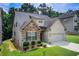 Charming two-story home with a combination of stone and brick exterior and two car garage at 555 Lance View Ln, Lawrenceville, GA 30045
