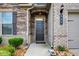 Close up of the front door with stylish fixtures, stone accents, and the house number displayed prominently at 555 Lance View Ln, Lawrenceville, GA 30045