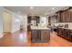 Spacious kitchen boasting an island with granite countertops, stainless steel appliances, and dark wood cabinetry at 555 Lance View Ln, Lawrenceville, GA 30045