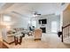 Cozy living room with a fireplace, comfortable seating, a tray ceiling, and access to the backyard through a glass door at 555 Lance View Ln, Lawrenceville, GA 30045