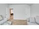 Bright living room featuring plush sofas, neutral carpeting, and doorway at 555 Lance View Ln, Lawrenceville, GA 30045