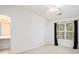 The main bedroom features large windows, neutral walls, and carpeted floors at 6540 Arbor Gate Sw Dr # 3, Mableton, GA 30126