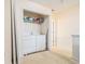 This laundry area features a stacked washer and dryer and wire shelving at 6540 Arbor Gate Sw Dr # 3, Mableton, GA 30126