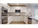 Modern kitchen with white cabinets, stainless steel appliances, granite countertops, and a large island at 1673 Fuma Leaf Way, Mcdonough, GA 30253