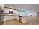 Well-lit kitchen features stainless steel appliances, granite countertops, white cabinetry, and an open concept layout at 1673 Fuma Leaf Way, Mcdonough, GA 30253