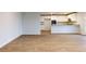 The expansive living room flows into the kitchen, which boasts granite counters and bright white cabinets at 1673 Fuma Leaf Way, Mcdonough, GA 30253