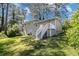 Rear exterior view of the house with a sprawling lawn and outdoor access at 2641 Clifton Springs Rd, Decatur, GA 30034