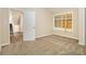 Bedroom with boarded up window and adjacent staircase at 2641 Clifton Springs Rd, Decatur, GA 30034