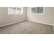 Neutral bedroom with two windows and carpet flooring at 2641 Clifton Springs Rd, Decatur, GA 30034