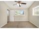 Serene bedroom featuring soft carpet, ceiling fan, and natural light at 2641 Clifton Springs Rd, Decatur, GA 30034