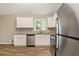 Modern kitchen featuring white cabinets, granite countertops, and stainless steel appliances at 2641 Clifton Springs Rd, Decatur, GA 30034