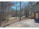 A beautiful backyard view with mature trees, a partial golf course, and convenient access to the house and wooden deck at 9001 E Carroll Rd, Winston, GA 30187