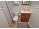 Cozy bathroom with beadboard walls, a wood vanity, and neutral color palette at 9001 E Carroll Rd, Winston, GA 30187
